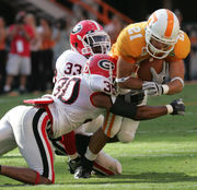 Chicago Bears linebacker Hunter Hillenmeyer (92) tackles Green Bay Packers  receiver Donald Driver (80) after a