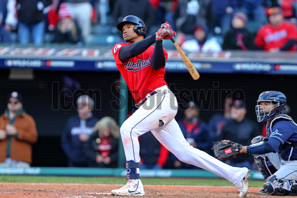 Cleveland Guardians right fielder Oscar Gonzalez flips his bat