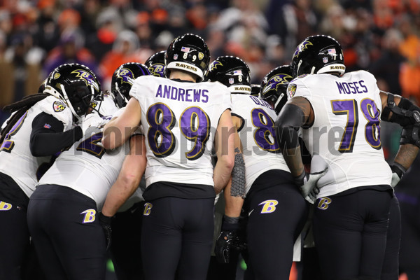 Baltimore Ravens vs. Cincinnati Bengals. NFL match poster. Two american  football players silhouette facing each other on the field. Clubs logo in  background. Rivalry concept photo. Stock Photo