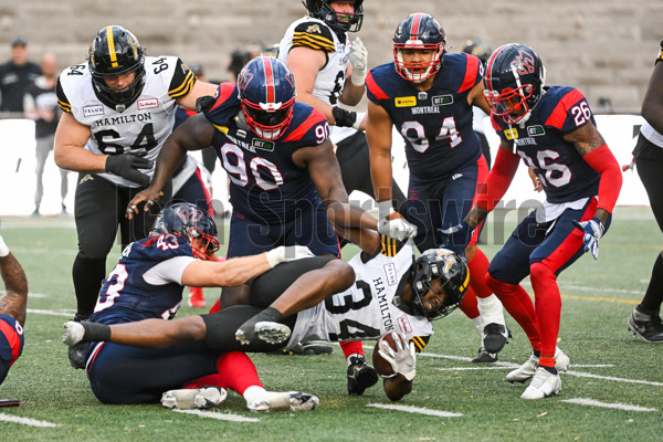 Hamilton Tiger-Cats defensive back Javien Elliott hands the ball